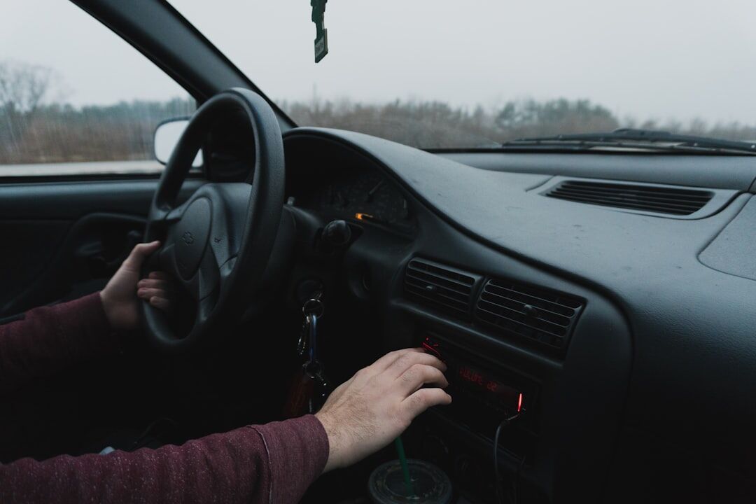 person driving luxury car