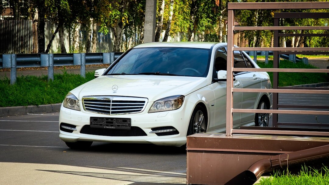White executive sedan on an empty road