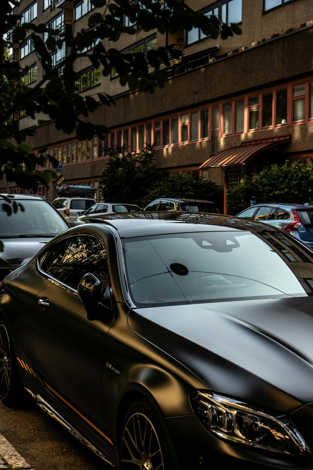 Black luxury coupe parked at night
