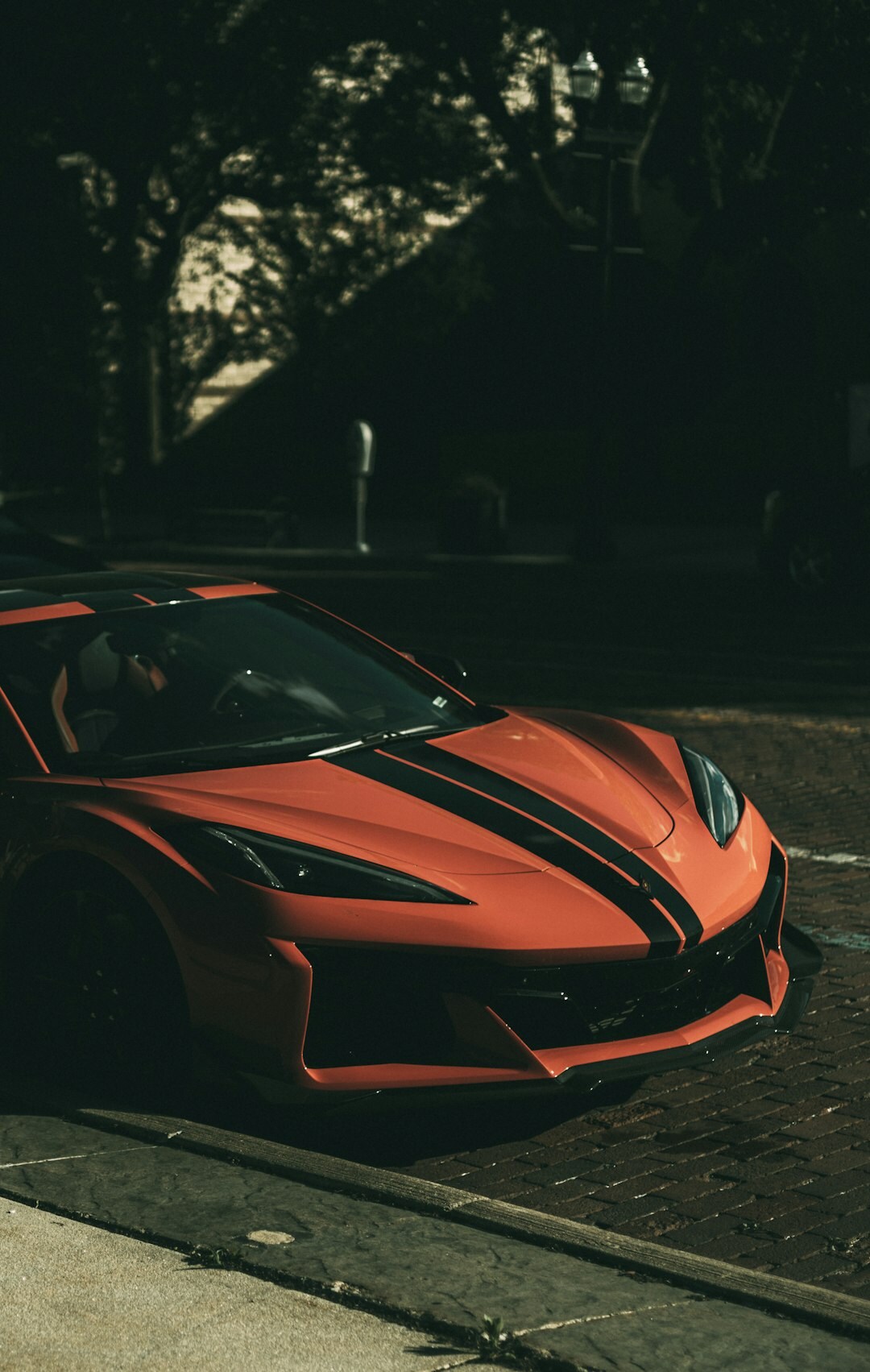 Red sports car parked in an urban setting